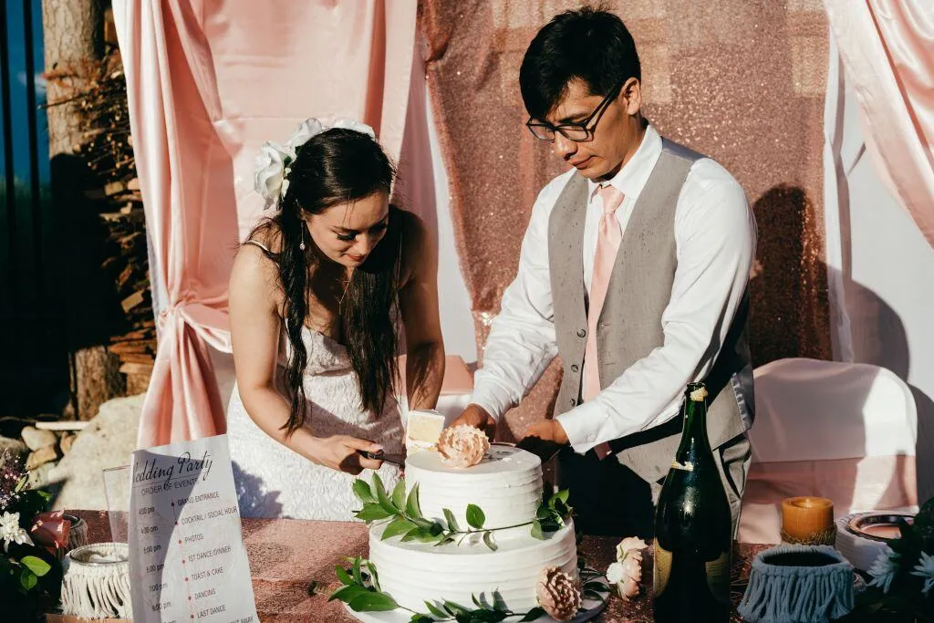 bride and groom cutting wedding cake